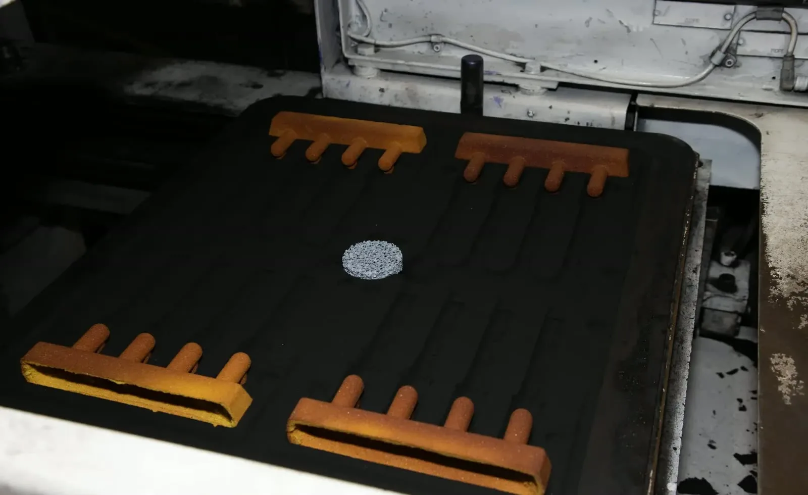 Green sand mold with cores set in place and a ceramic filter, before closing